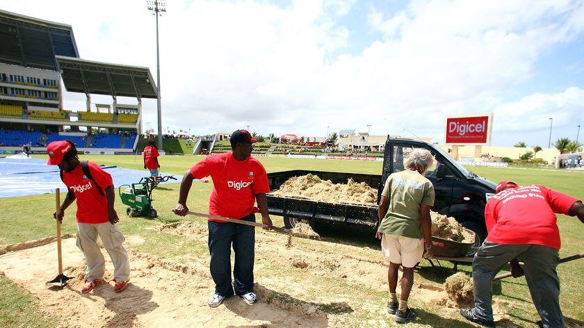 Groundsmen work on Antigua pitch