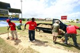 Groundsmen work on Antigua pitch