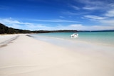 A stunning beach with white sand and turquoise water.