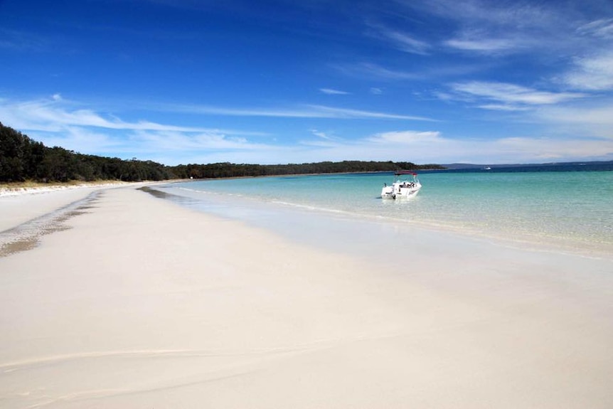 A stunning beach with white sand and turquoise water.