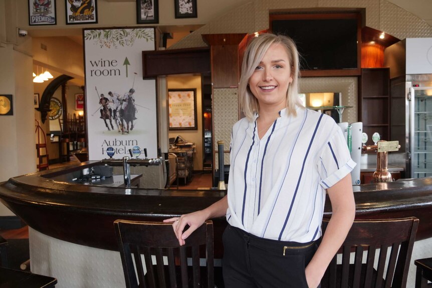 Heather Eiswirth stands at the bar at the historic pub