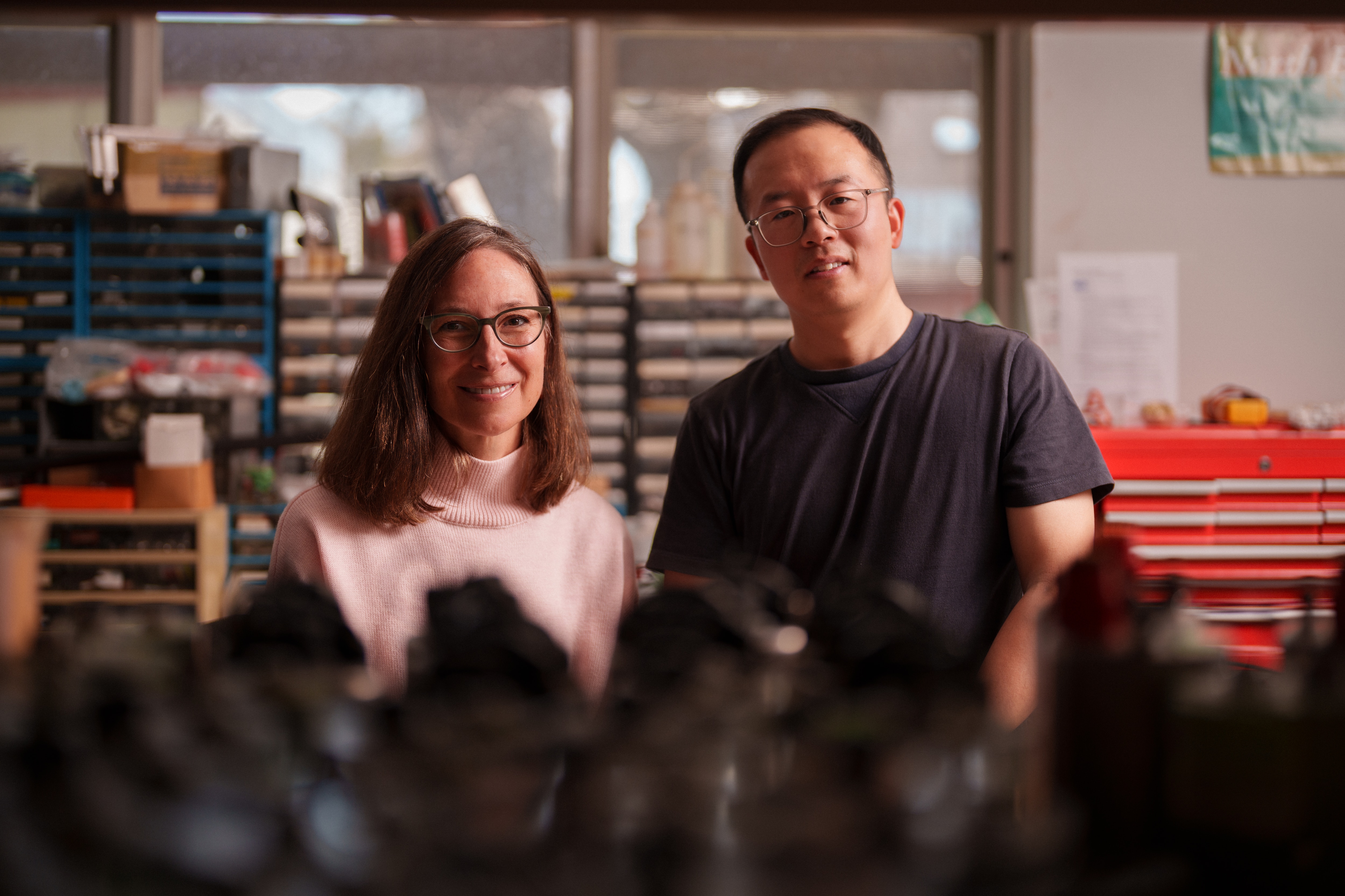 Dois cientistas estão lado a lado em uma sala de trabalho.