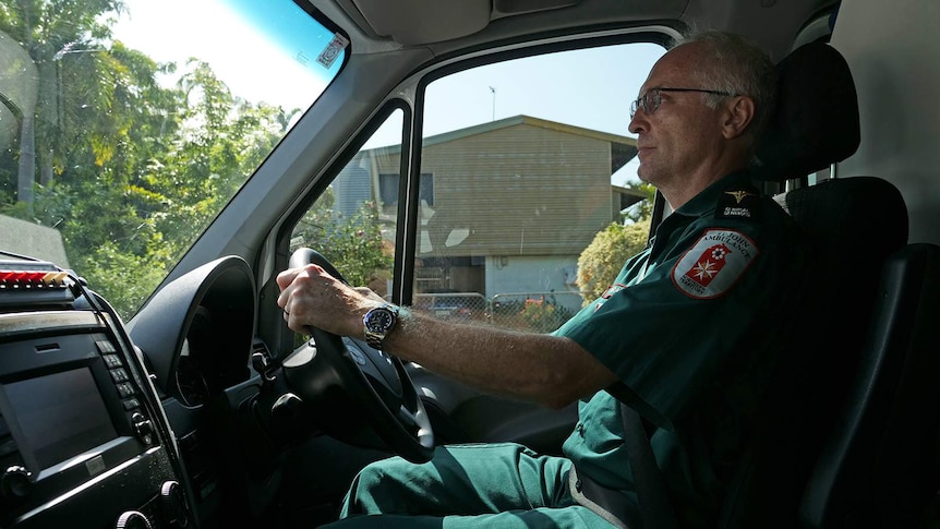 A photo of a paramedic instructor at the wheel of an ambulance.