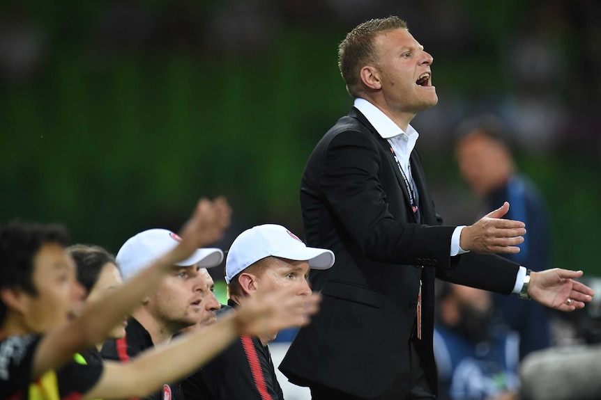 Western Sydney Wanderers coach Josep Gombau stands and remonstrates on the sideline against Melbourne City.