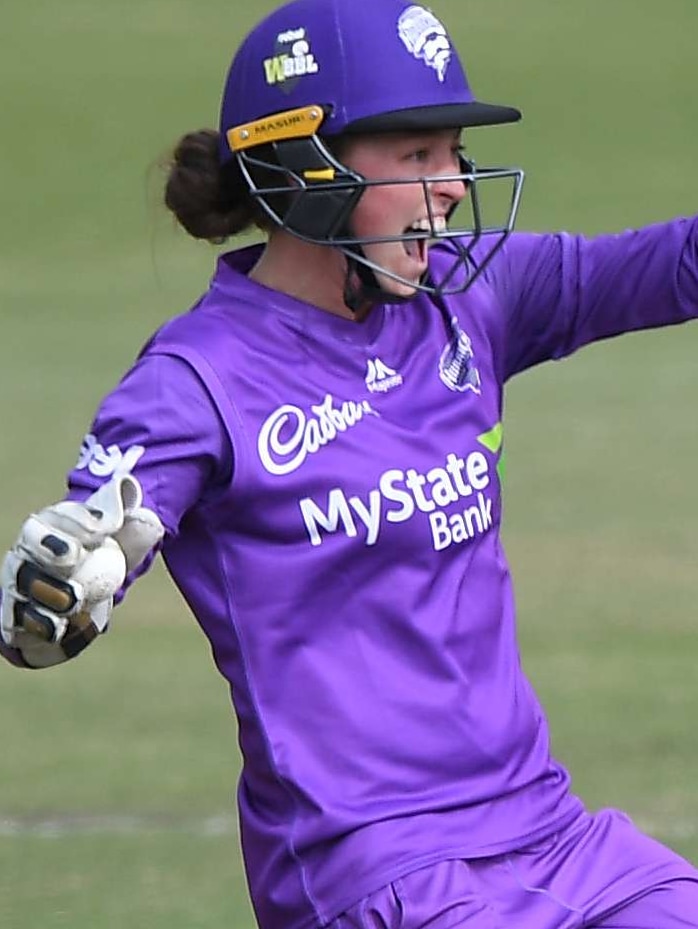 A Hobart Hurricanes WBBL wicketkeeper yells out after she holds up her left glove.
