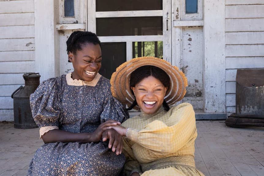 Phylicia Pearl Mpasi as Young Celie and Halle Hailey as Young Nettie both laughing, hands together