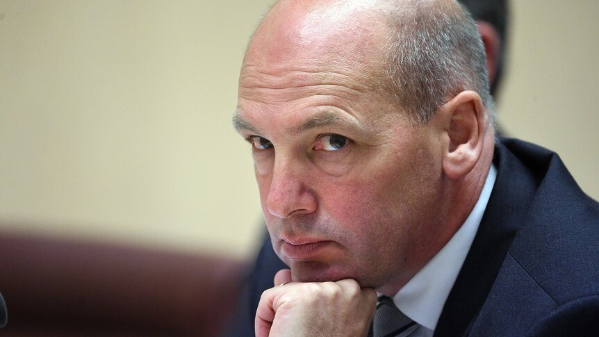 Stephen Parry rests his chin on his fist looking pensive