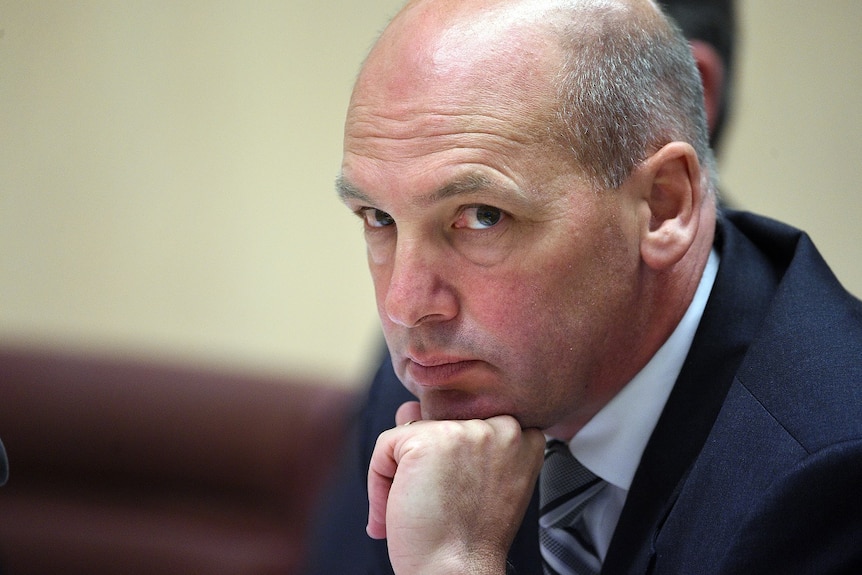 Stephen Parry rests his chin on his fist looking pensive