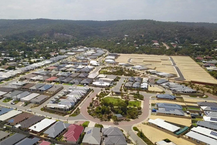 An aerial view of houses and vacant blocks.