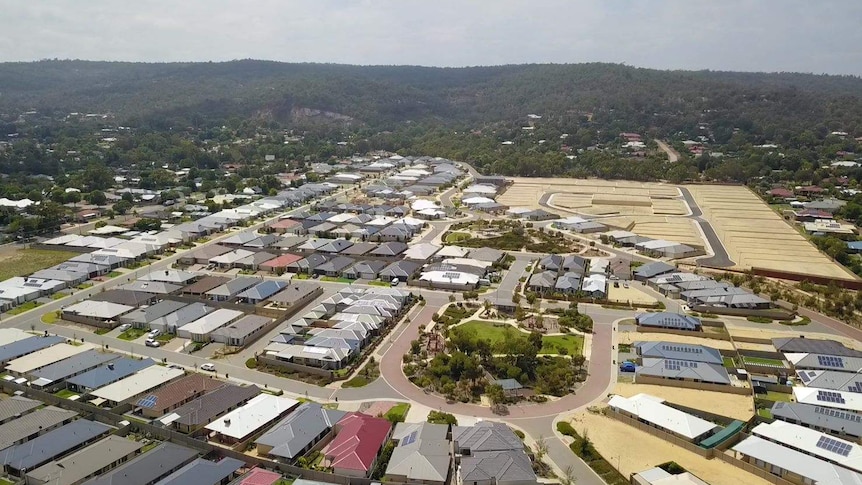An aerial view of houses and vacant blocks.