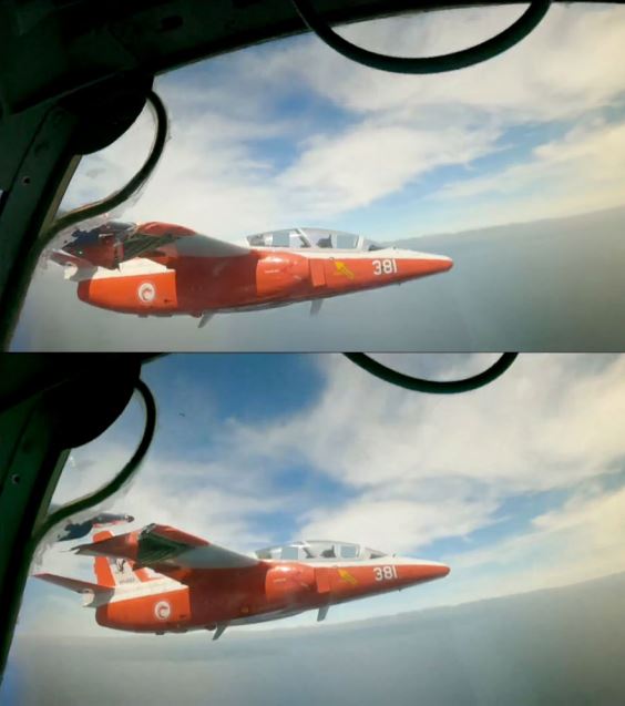 A red and white plane with damaged wing photo taken from inside another plane.