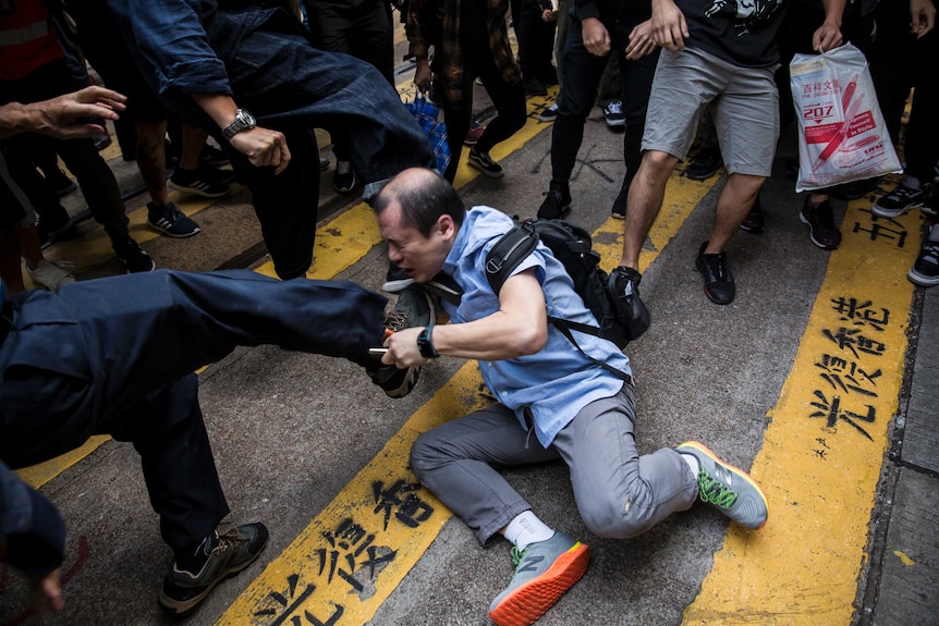 在香港市中心的示威活动中，一名男子因与人争论而遭殴打。
