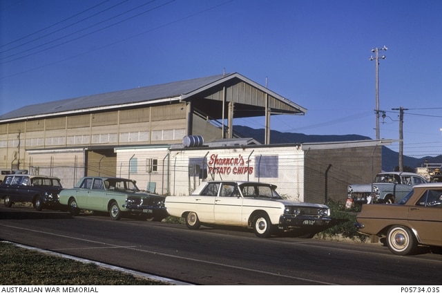 Historical photo of old cars outside the Cairns Showground.