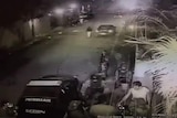 Still of video footage showing several Venezuelan security officers bundling Leopoldo Lopez into a car.
