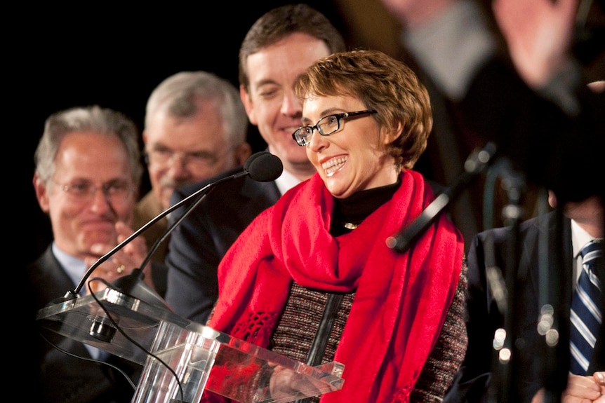 Gabrielle Giffords smiles at a first anniversary memorial service of the Tuscon shooting.