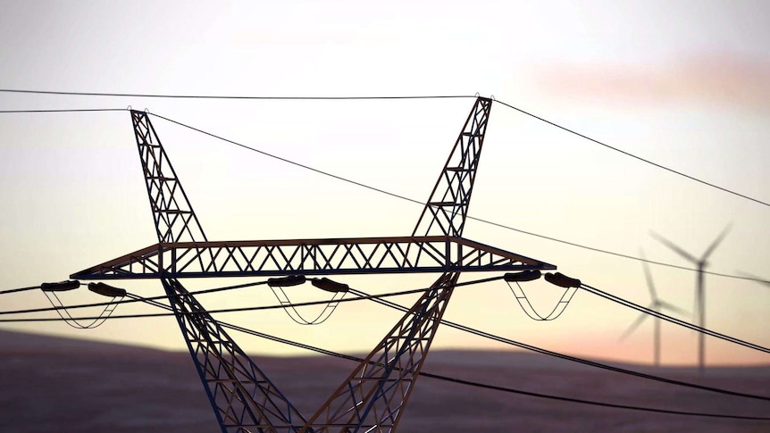 Powerlines with wind turbines in the distance.