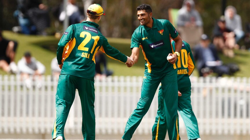 Gurinder Sandhu shakes hands with Jordan Silk after taking a wicket for Tasmania against Victoria in the one-day cup final.