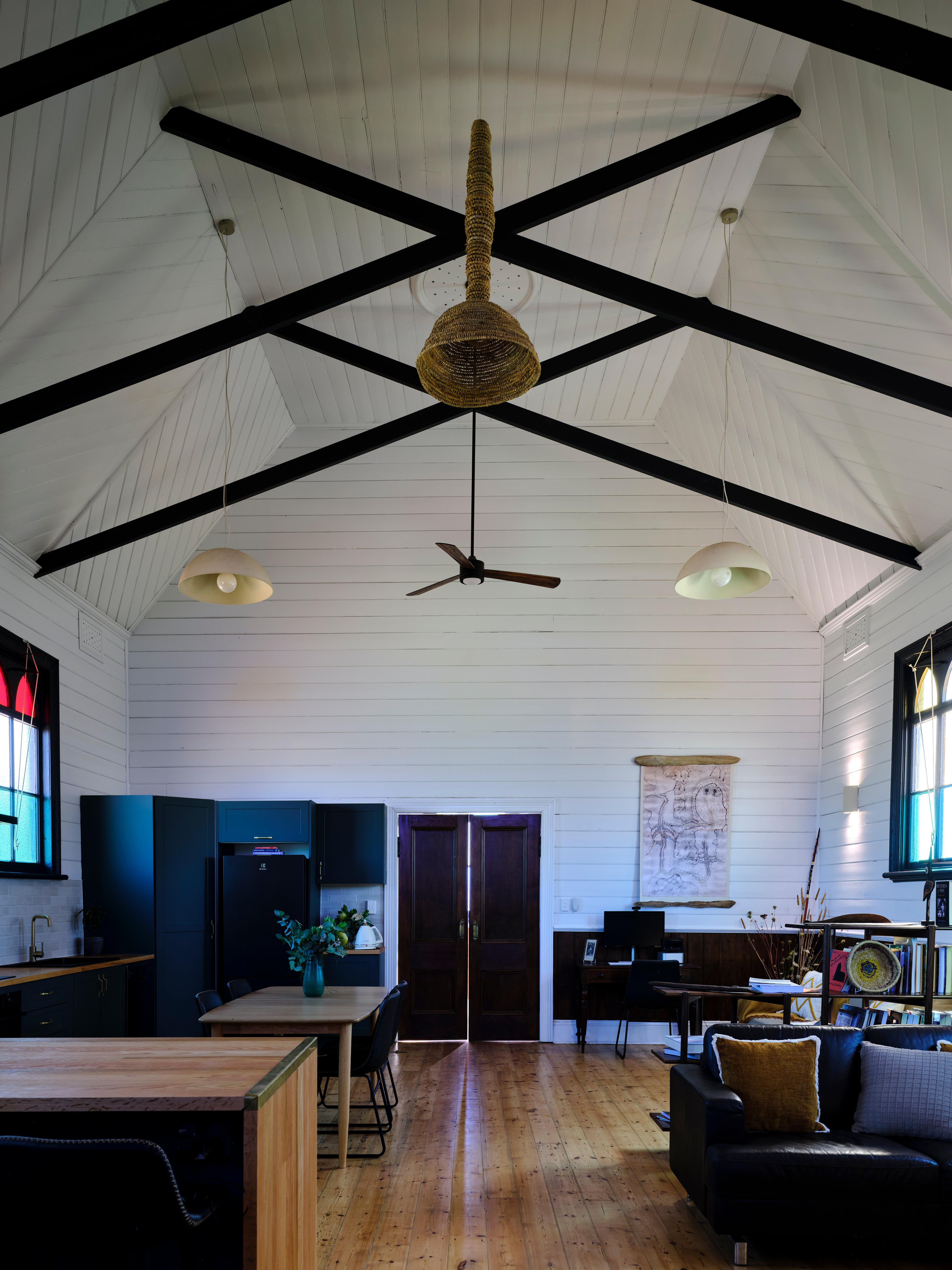A woven eel net attached to the ceiling as a light fixture.