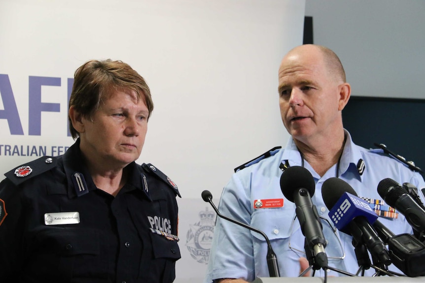 A female police officer and male federal police officer at a press conference about a drug seizure.