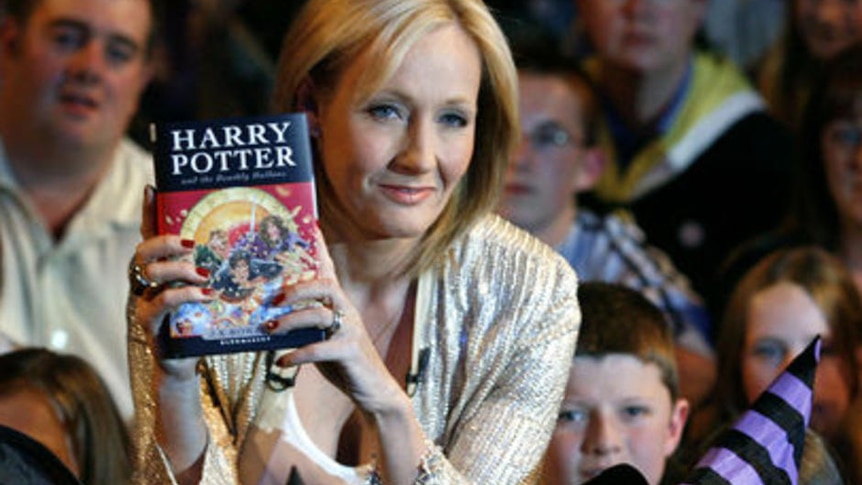 Author JK Rowling poses with a copy of Harry Potter and the Deathly Hallows [File photo].