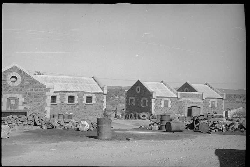 A black and white photo of an old brick jail complex.