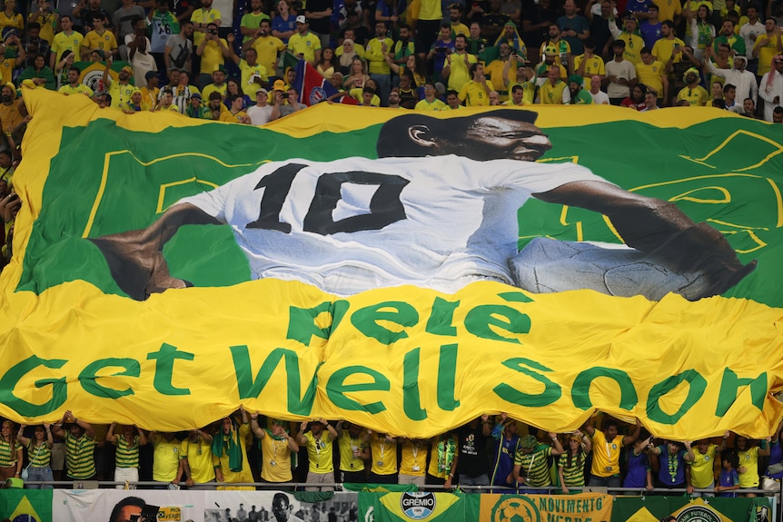 Brazil fans hold up a banner reading "Pele Get Well Soon" at the Qatar FIFA World Cup match against South Korea.