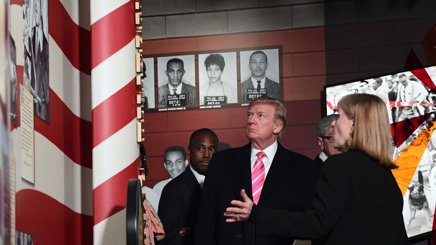 Donald Trump with Ben Carson and Lucy Allen look at a photo exhibit on the wall of the Mississippi Civil Rights Museum
