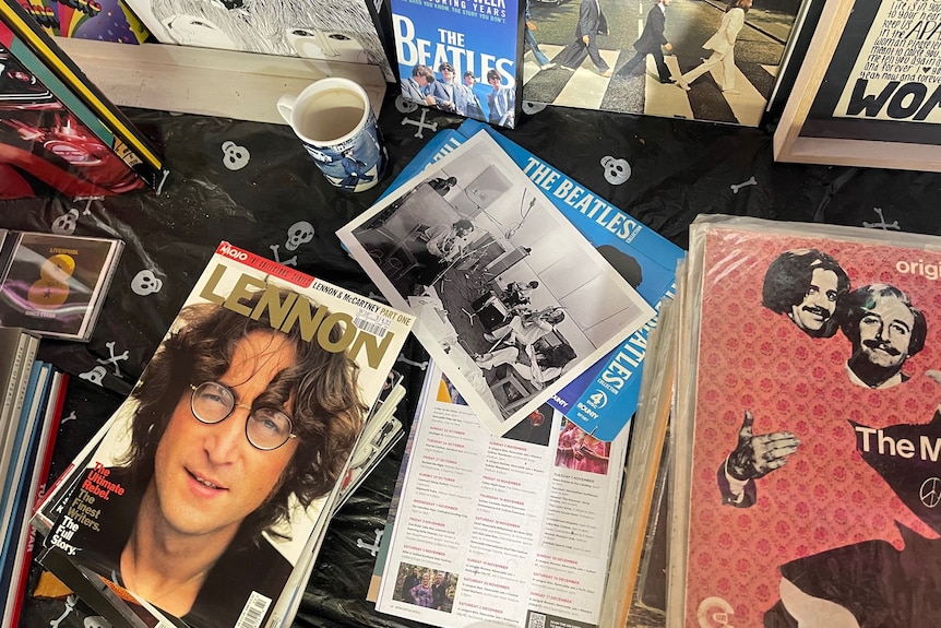 A bird eye view of a table with Beatles memorabilia scattered across it