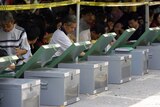 Officials check ballot boxes for Thailand's elections at a district office in Bangkok