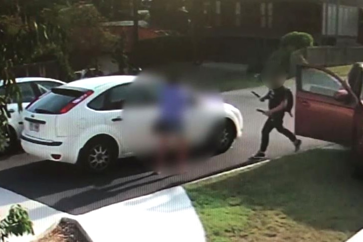 CCTV of man approaching woman and children with a knife and sword.