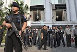 Indonesian counter-terrorist police commandos secure the damaged Ritz-Carlton hotel in Jakarta