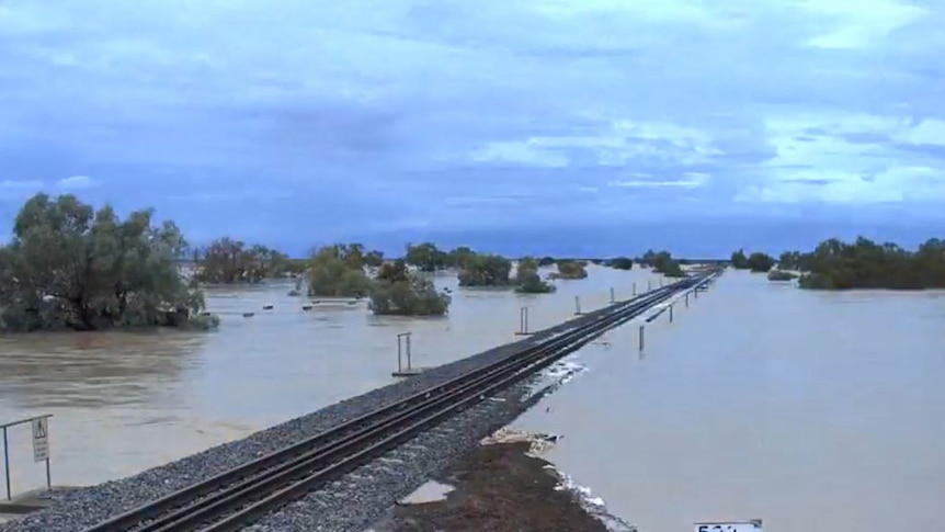 Flooding engulfs a freight train line at Corella Creek in north-western Queensland. (Supplied: QR)