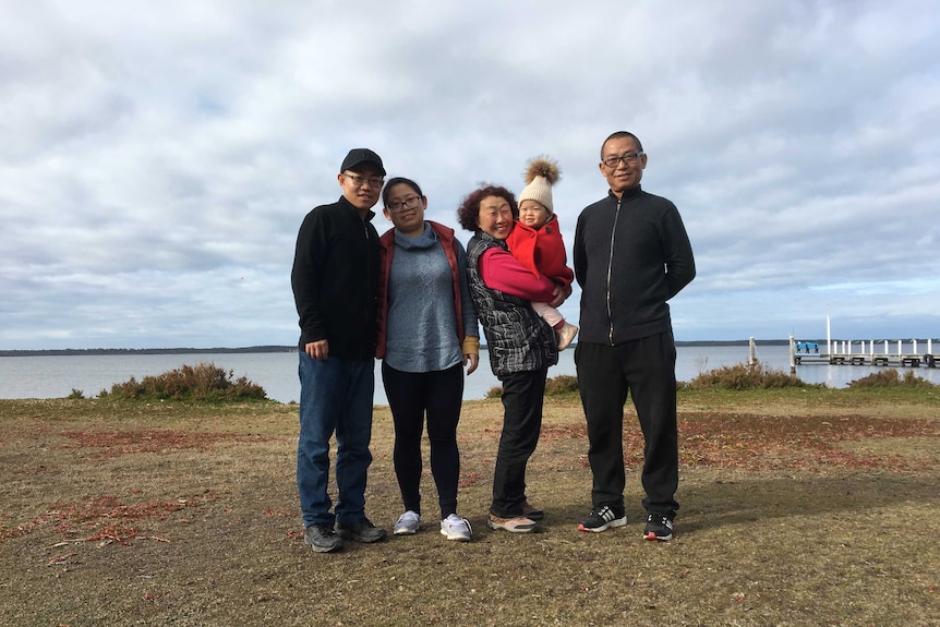 Dong Liu and Lixia Wang with their son Can Liu, his wife Julie Jin and their child Emma Liu in Lixia's arm.