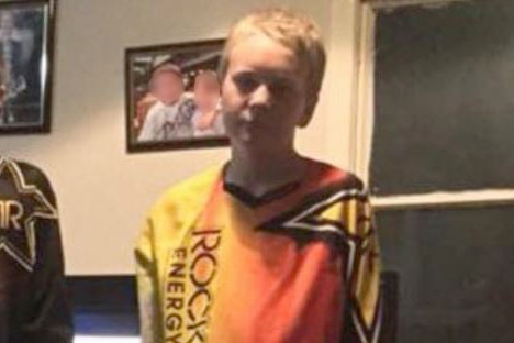 Missing 14-year-old boy Blake Burke wears a brightly coloured motorbike top.
