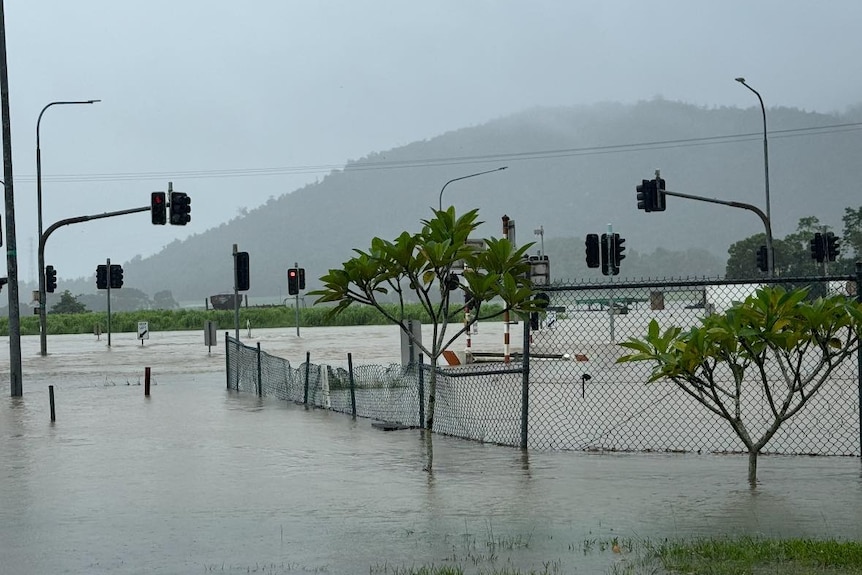 Traffic lights above a flooded road in a country town.