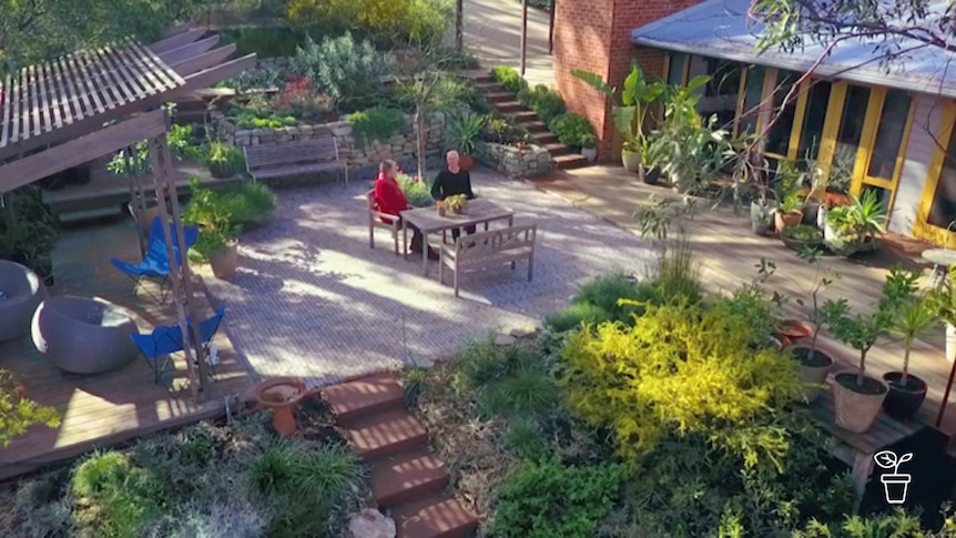 Man and woman sitting at outdoor table and chairs in the garden
