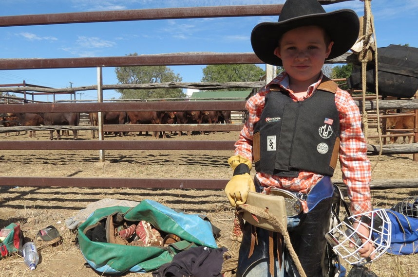 Five-year-old Dustin Roots at the Longreach rodeo school to learn to ride poddy calves in August, 2013