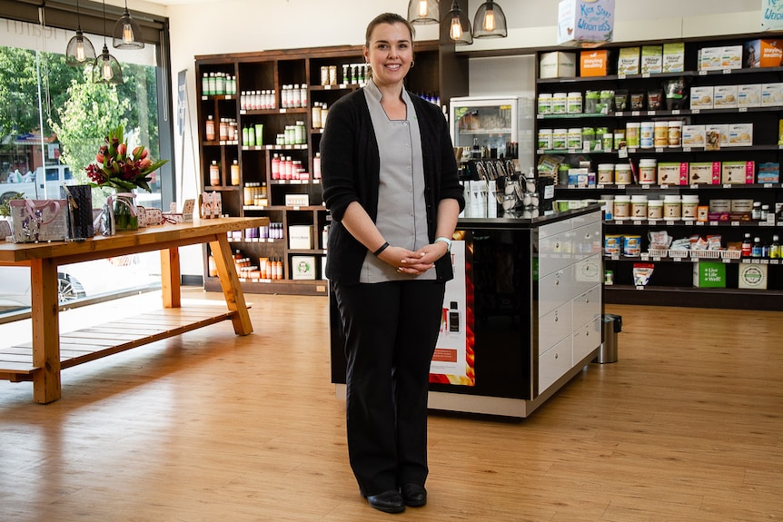 Nutrition consultant Jessie Parish standing inside retail pharmacy store to depict tips for people standing all day.