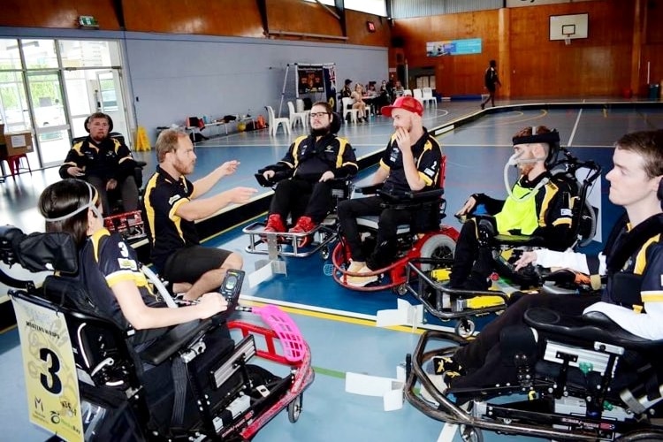 Jack O'Keeffe gesticulating while coaching in a powerchair