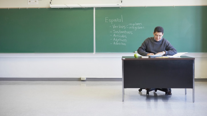 Lecturer sitting at desk (Jack Hollingsworth: Thinkstock)