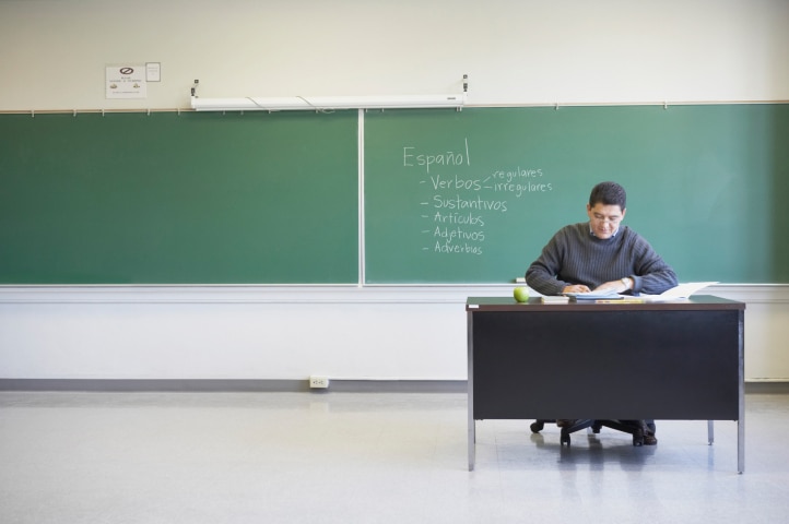 Lecturer sitting at desk (Jack Hollingsworth: Thinkstock)