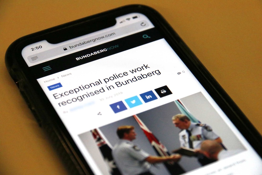 Bundaberg Now website on a mobile phone showing an article titled "Exceptional police work recognised in Bundaberg"