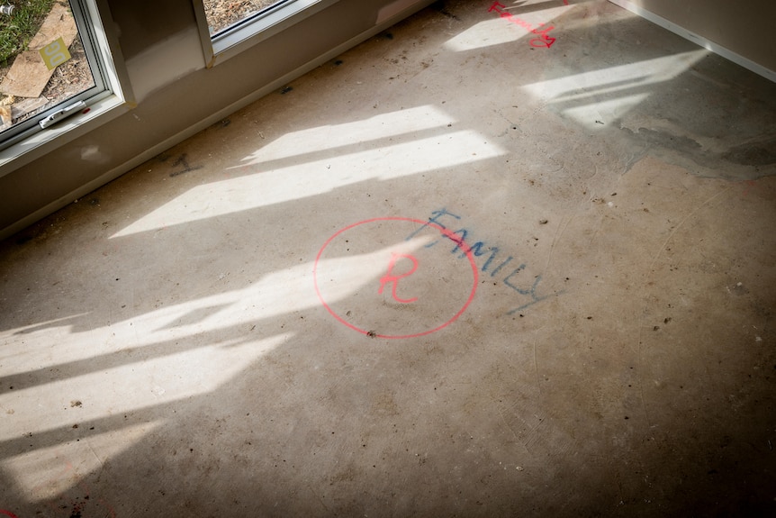 An uncovered floor with the word 'family' written in blue pen.