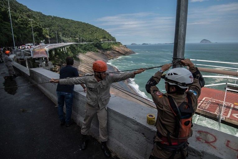 Workers at the site where a recently inaugurated bicycle track collapsed.