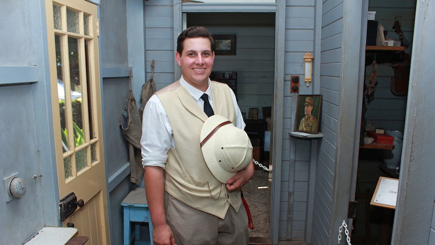 Young man in vintage attire in old homestead house