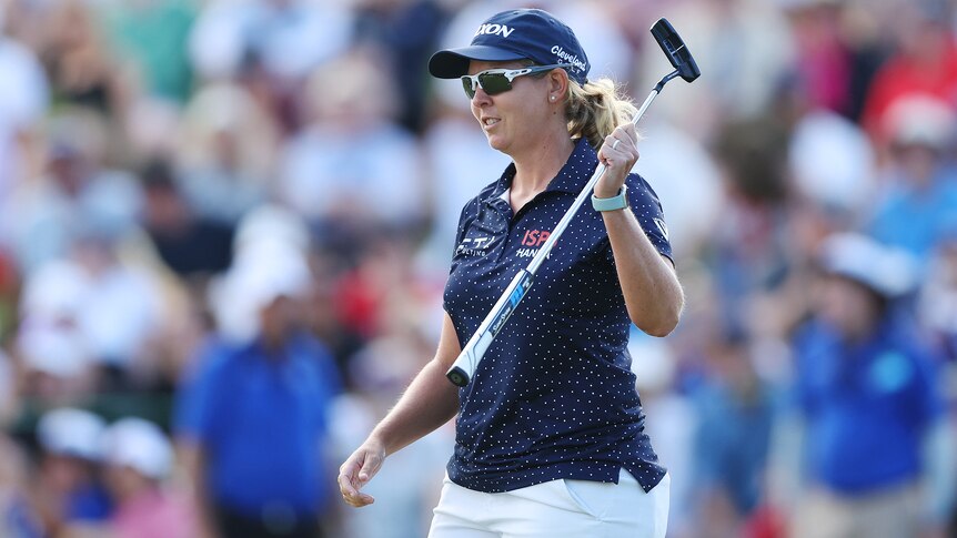 A South African golfer celebrates winning the women's Australian Open.