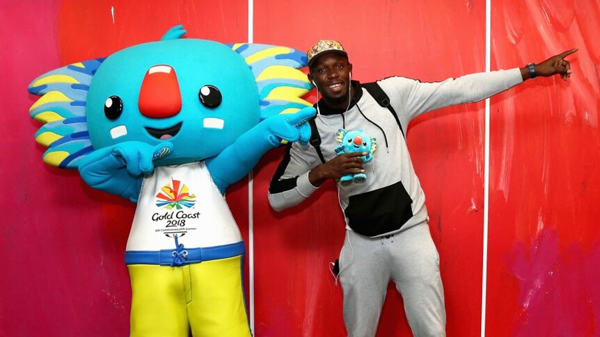 Olympic sprinter Usain Bolt strikes a signature pose with Commonwealth Games mascot Borobi.