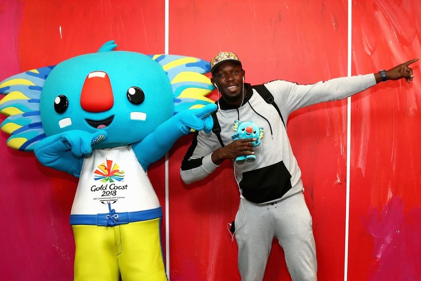 Olympic sprinter Usain Bolt strikes a signature pose with Commonwealth Games mascot Borobi.