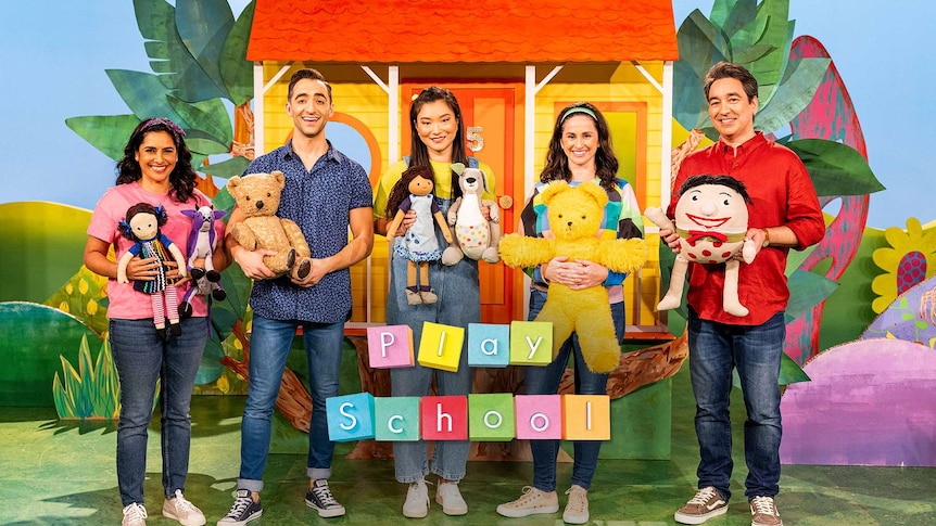 Play School characters Jemima, Big Ted, Humpty and Little Ted sitting on cube seats with two Play School presenters