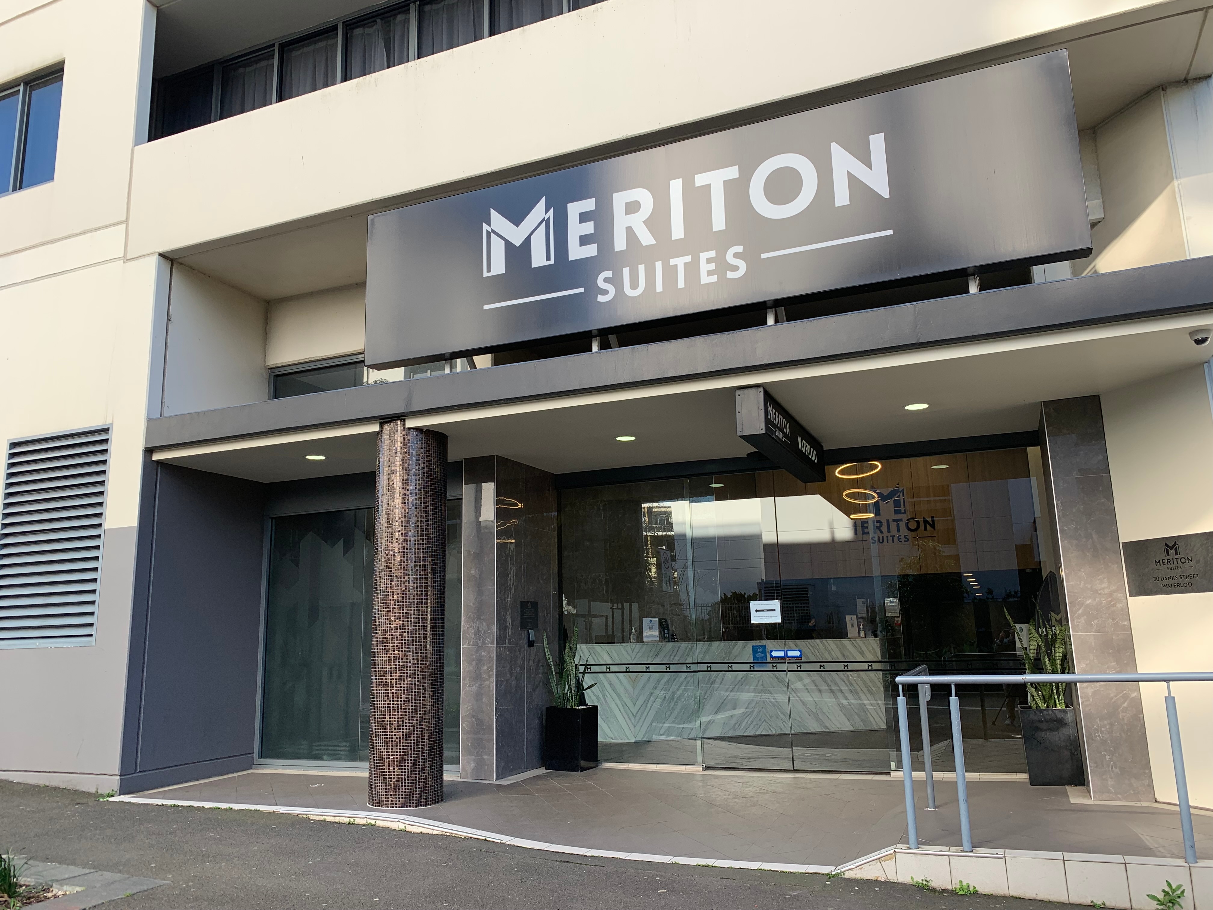A doorway with the words Meriton Suites written at the top.